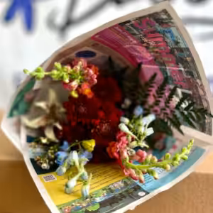 Flower bouquet wrapped in colorful newspaper