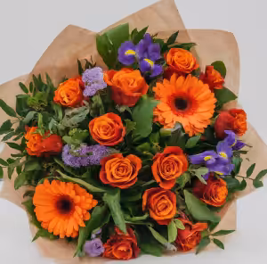 Vibrant flower bouquet with orange roses, gerbera daisies, purple irises, and greenery